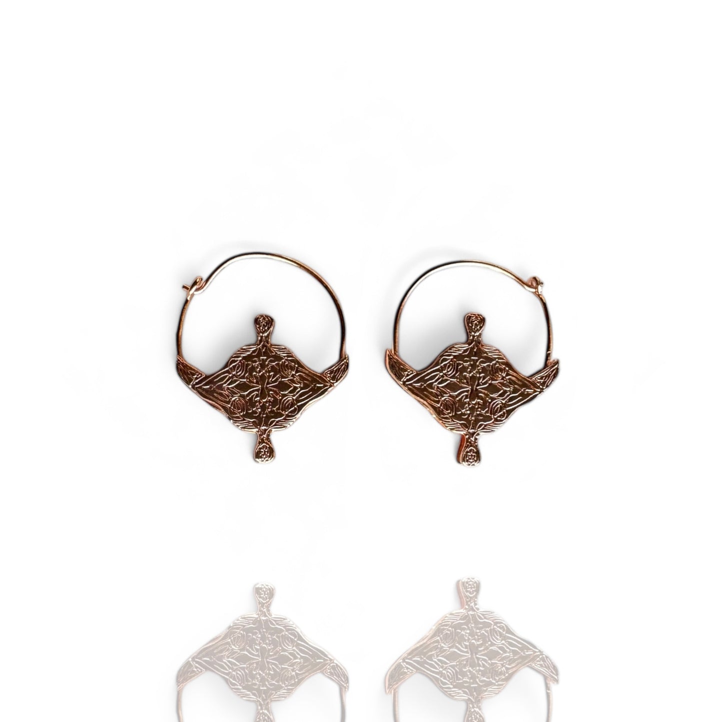 Pair of rose gold hoop earrings on a white background