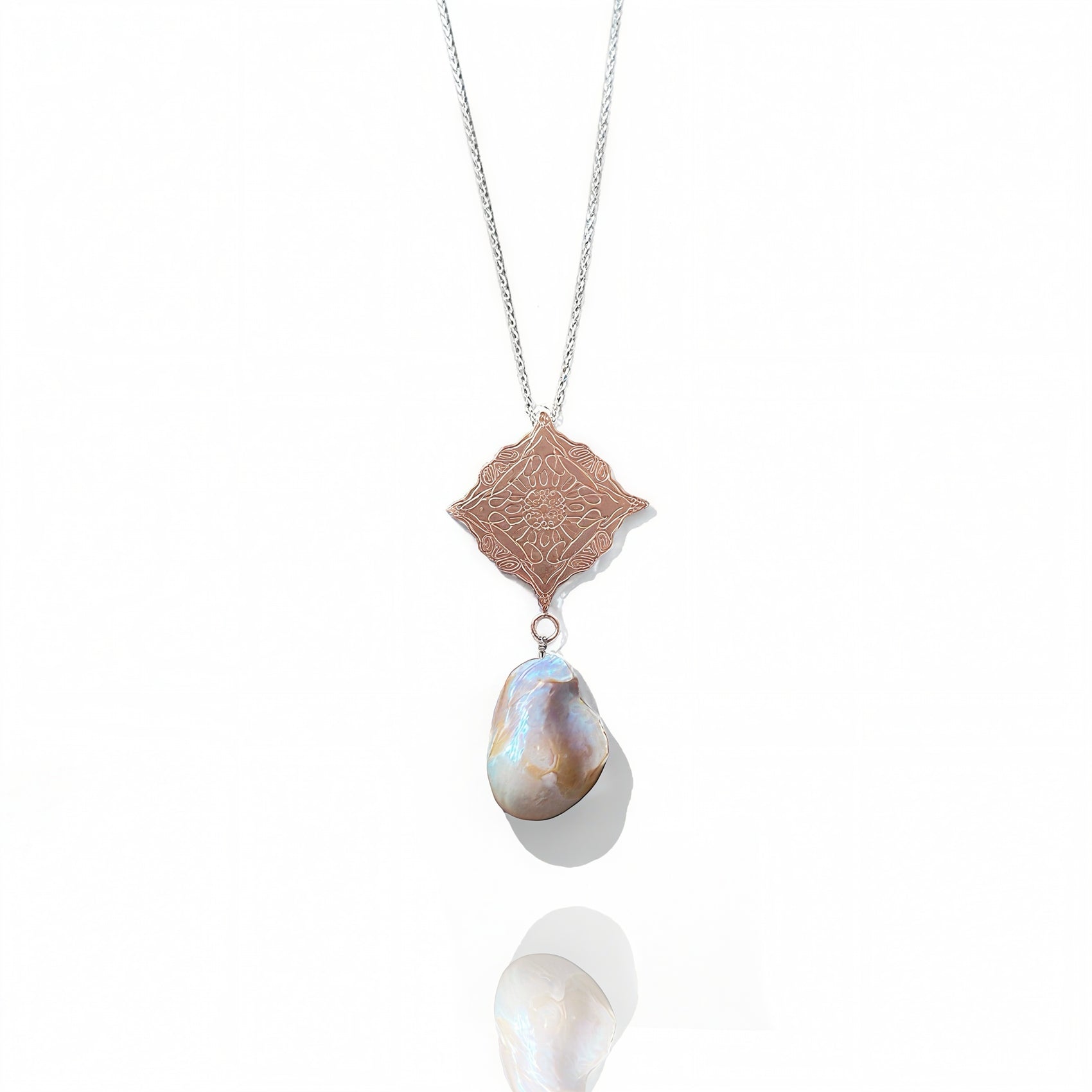 Rose Gold Necklace with a pendant featuring a large pearl and intricate design on a white background