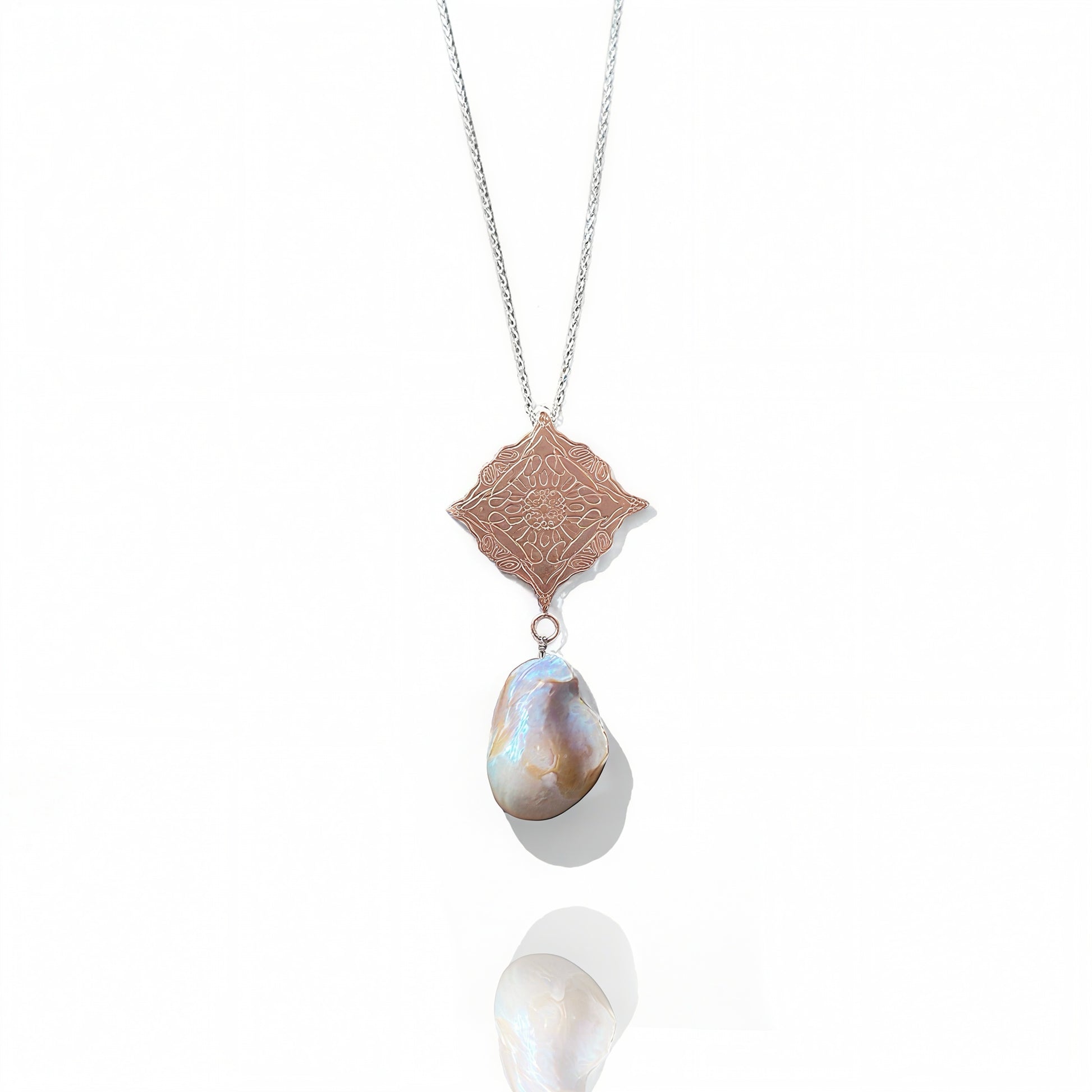 Rose Gold Necklace with a pendant featuring a large pearl and intricate design on a white background