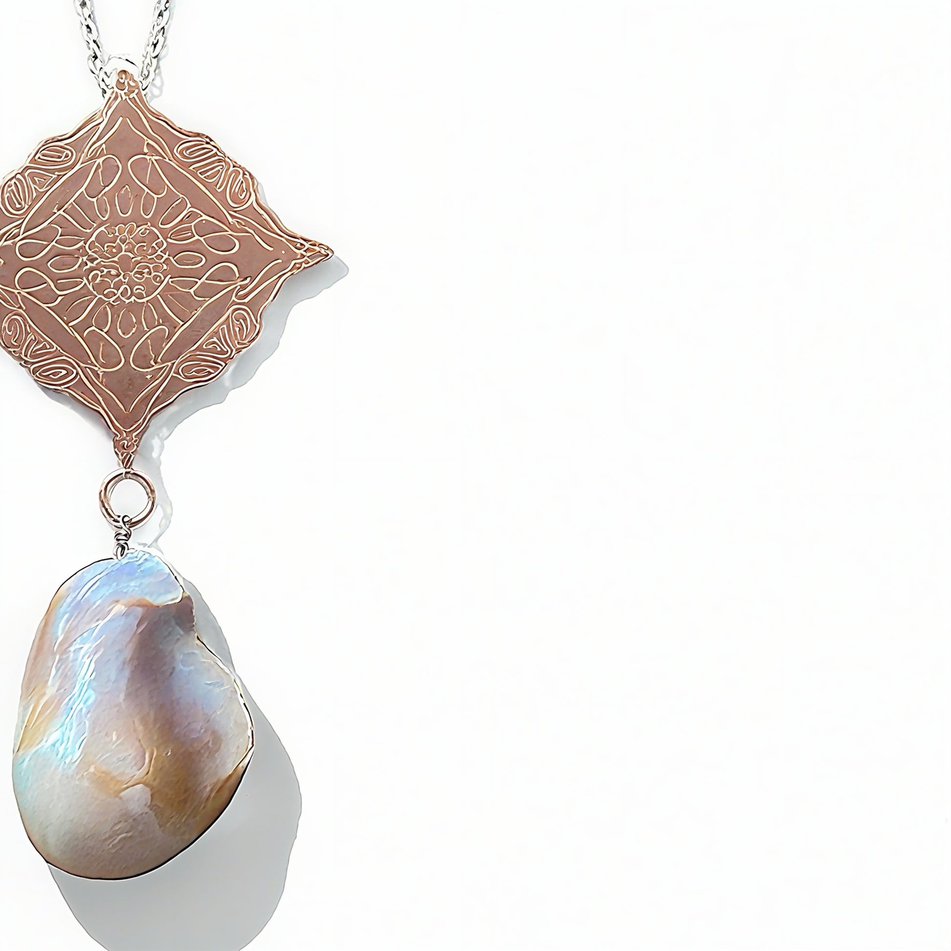Necklace with a rose gold pendant and a large pearl pendant on a white background