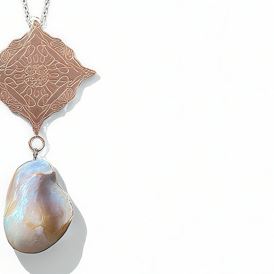 Necklace with a rose gold pendant and a large pearl pendant on a white background
