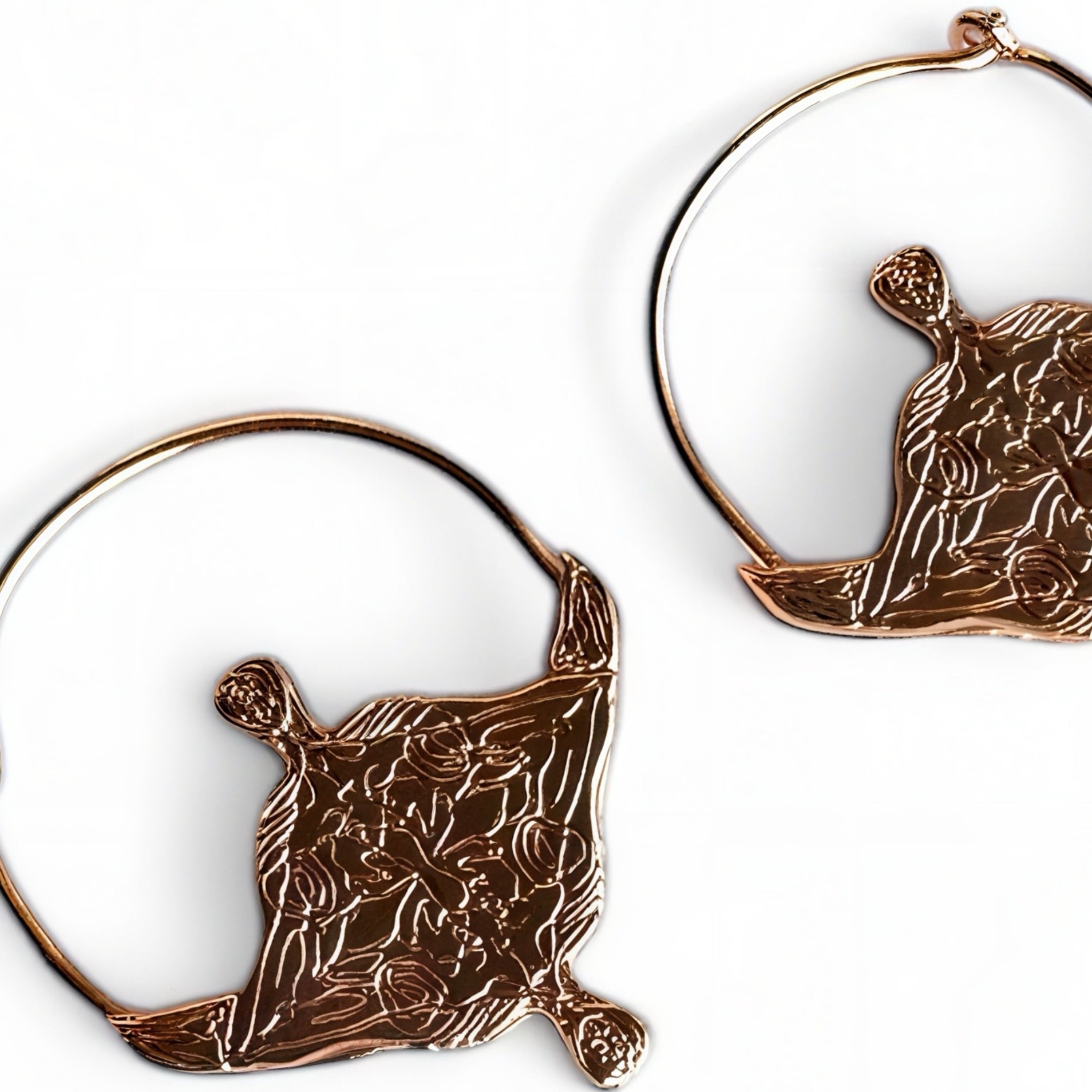 Pair of hoop earrings with designs on a rose gold plated on a white background